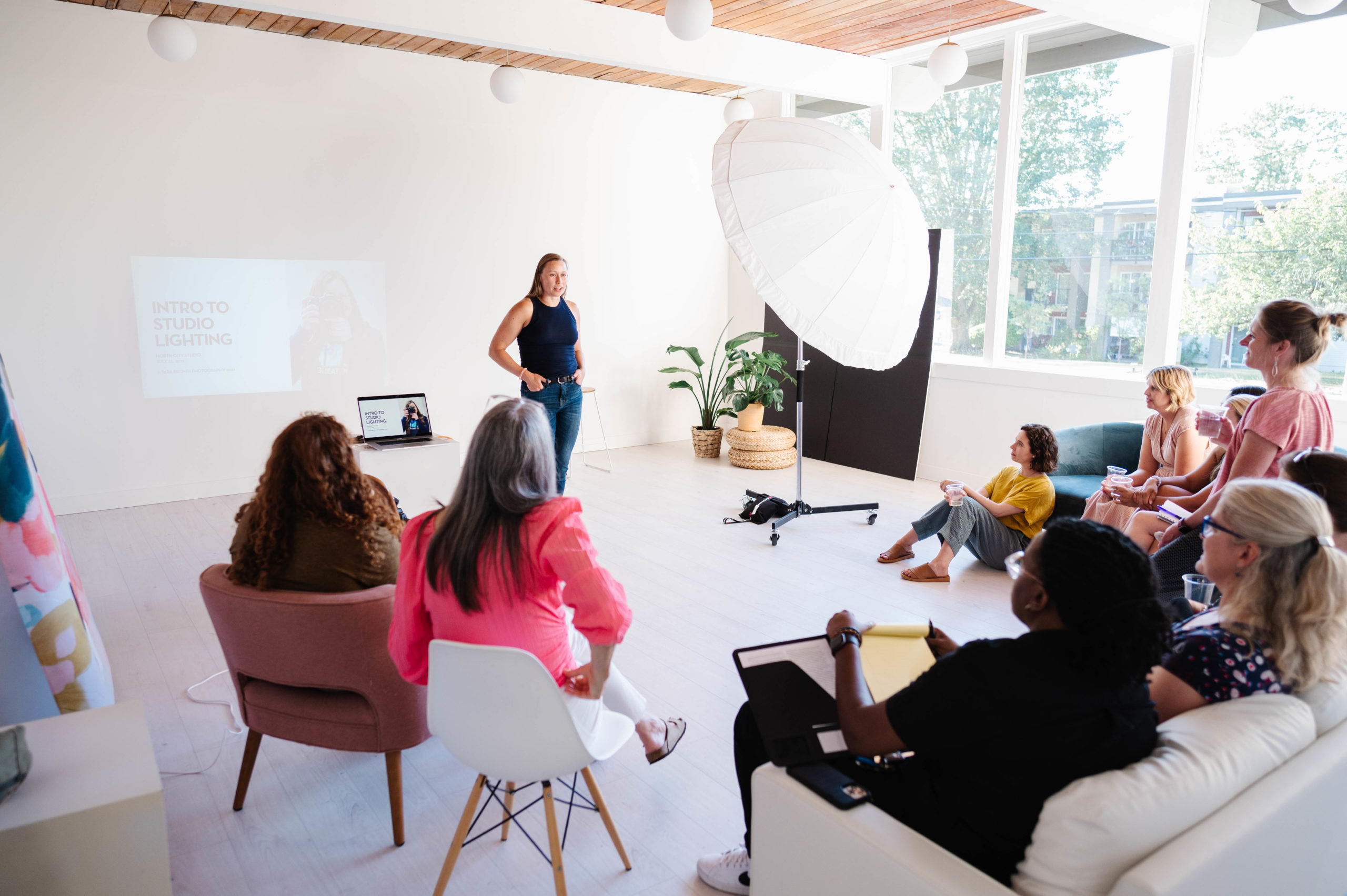 woman making a photography presentation to a group of women